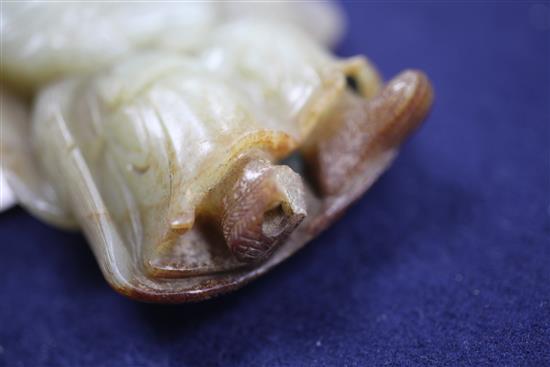 A Chinese celadon and russet skin jade figure of a fisherman, 18th / 19th century, 10cm., loss to right foot, carved wood stand